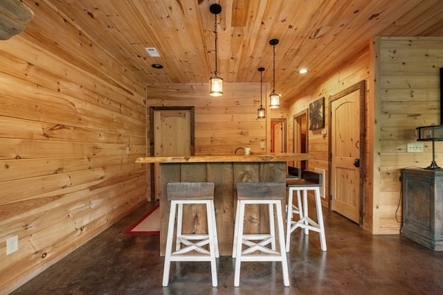 interior space featuring wooden ceiling, wooden walls, and pendant lighting