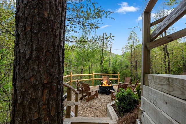 wooden deck with an outdoor fire pit