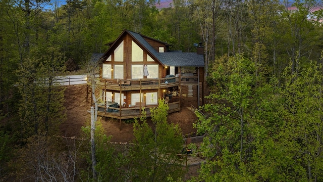 back of property featuring a deck