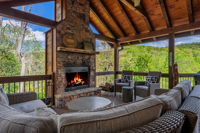 wooden deck featuring an outdoor living space with a fireplace