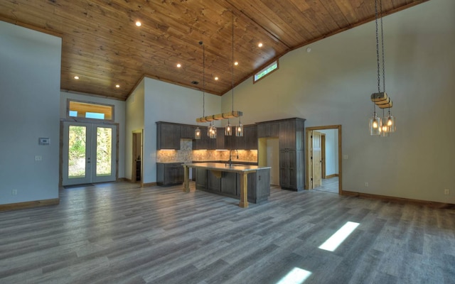 kitchen with wood ceiling, high vaulted ceiling, a center island, and decorative light fixtures