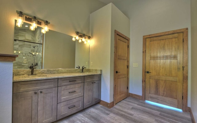 bathroom with vanity, hardwood / wood-style floors, and an enclosed shower