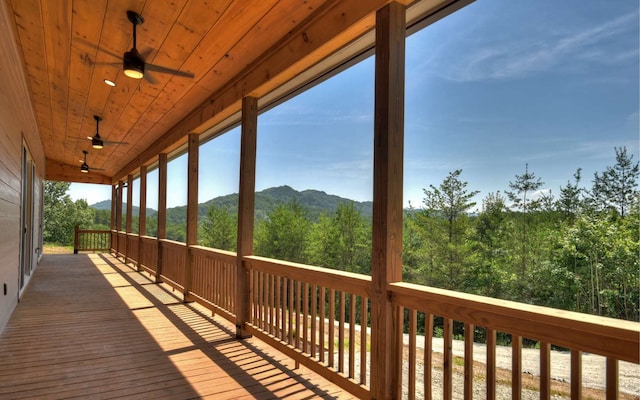 deck with a mountain view and ceiling fan