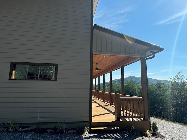 view of side of home with a deck with mountain view