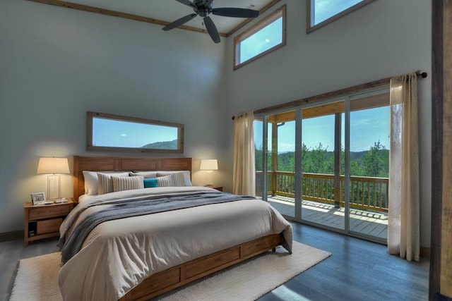 bedroom with ceiling fan, multiple windows, wood-type flooring, and access to outside