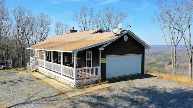 view of front facade with covered porch and a garage