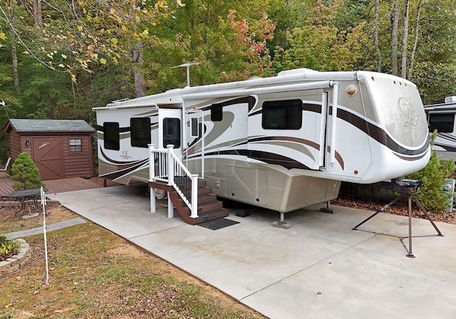 exterior space with a storage shed and a patio