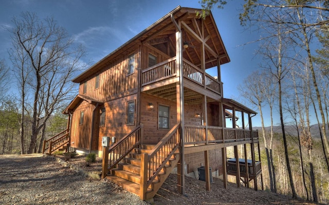 view of front of house with stairs and cooling unit