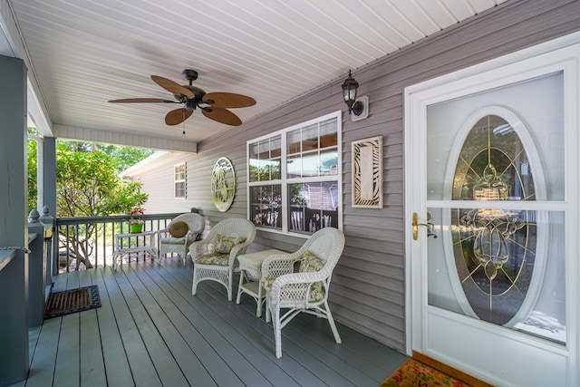 wooden deck featuring ceiling fan and a porch