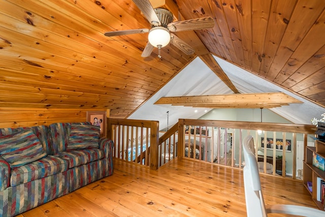 unfurnished room with lofted ceiling with beams, wooden ceiling, hardwood / wood-style floors, and an upstairs landing