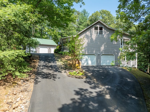 view of front facade featuring an attached garage and an outbuilding