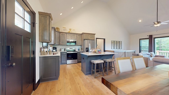 162 Barefoot Trl, Blairsville, GA 30512 - kitchen with stainless steel appliances, high vaulted ceiling, a breakfast bar area, light countertops, and a kitchen island