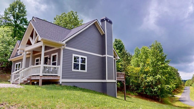 162 Barefoot Trl, Blairsville, GA 30512 - view of side of property with a chimney, covered porch, a yard, and roof with shingles