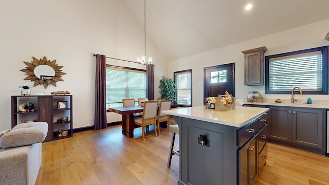 162 Barefoot Trl, Blairsville, GA 30512 - kitchen featuring light countertops, a chandelier, light wood-type flooring, a center island, and high vaulted ceiling