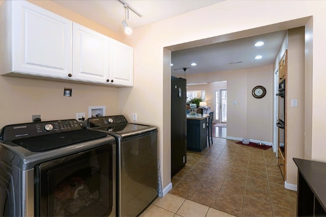 clothes washing area featuring recessed lighting, cabinet space, washing machine and clothes dryer, baseboards, and dark tile patterned flooring