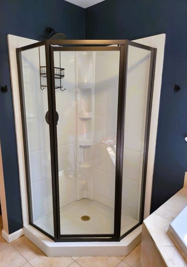 bathroom featuring tile patterned flooring and a stall shower