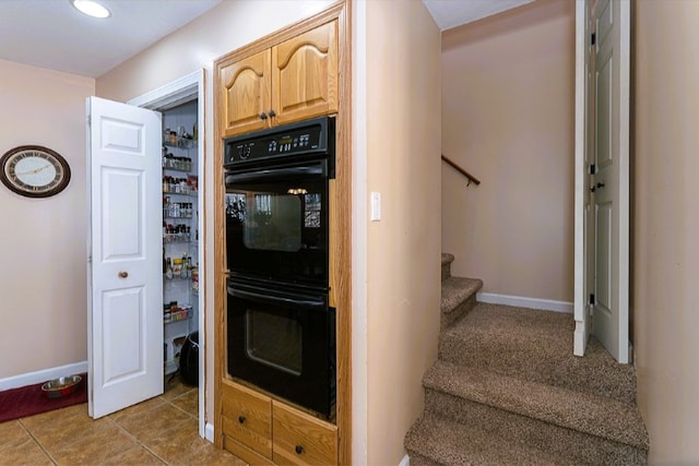 stairs with baseboards and tile patterned floors