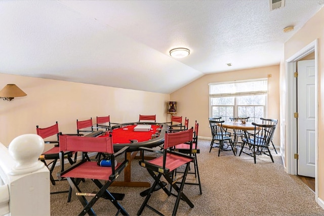 dining area featuring visible vents, carpet, baseboards, a textured ceiling, and lofted ceiling