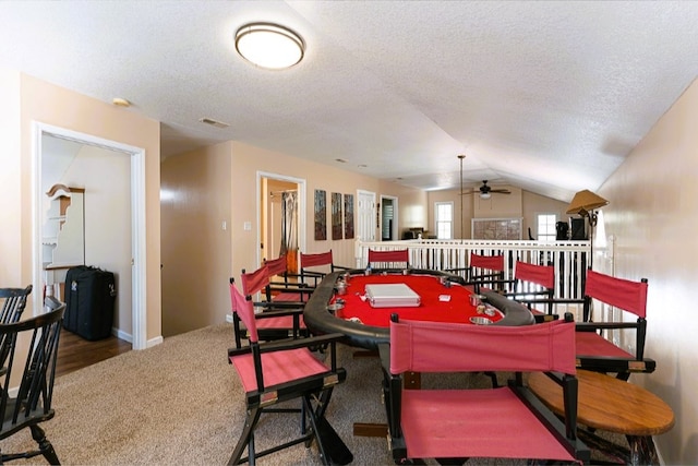 game room with carpet flooring, ceiling fan, baseboards, a textured ceiling, and lofted ceiling
