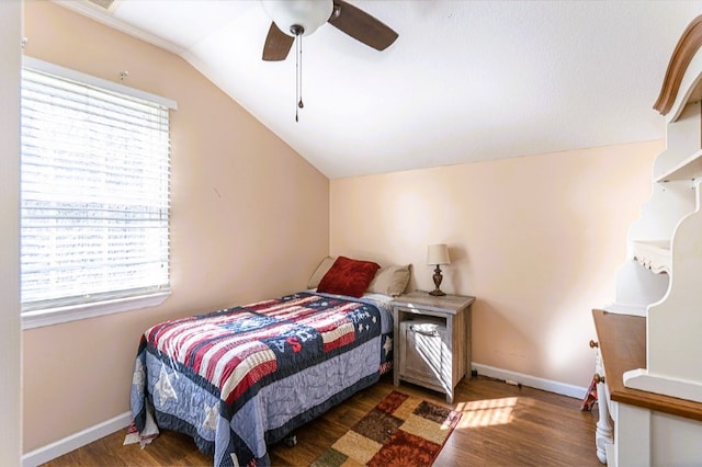 bedroom featuring wood finished floors, ceiling fan, vaulted ceiling, and baseboards