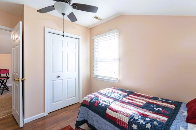 bedroom with visible vents, dark wood-style floors, baseboards, vaulted ceiling, and a ceiling fan