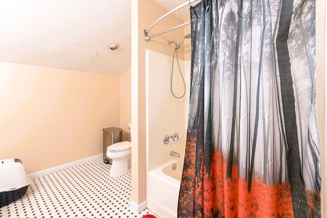 bathroom with shower / tub combo, toilet, and baseboards