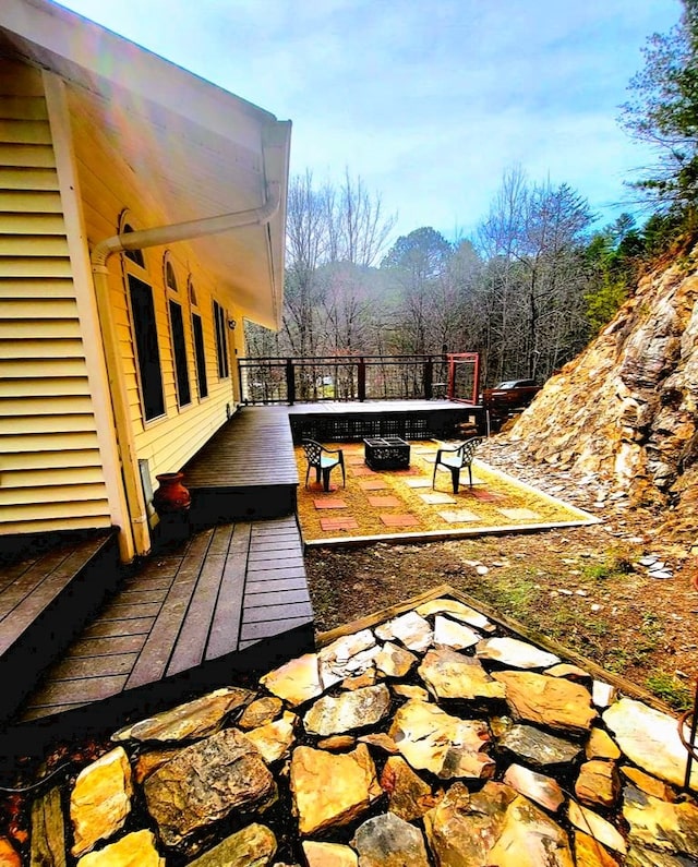 deck featuring an outdoor fire pit