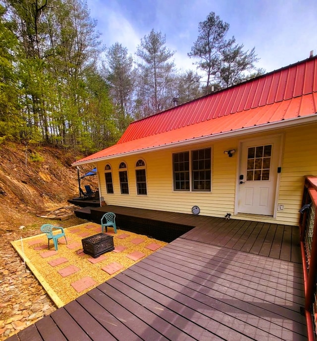 wooden deck featuring a fire pit