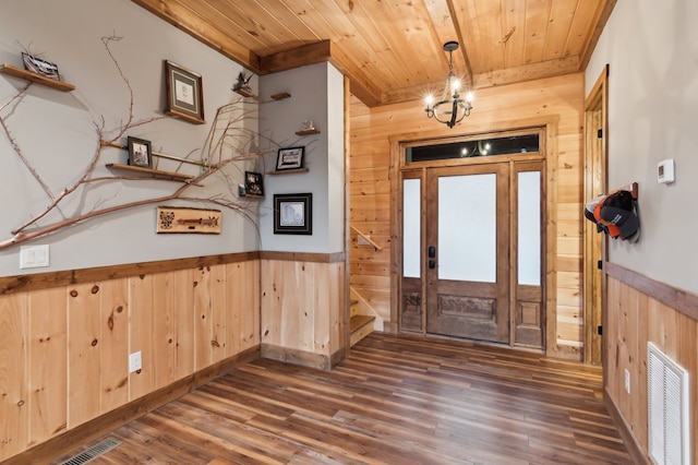 entryway with wood walls, wood ceiling, and visible vents