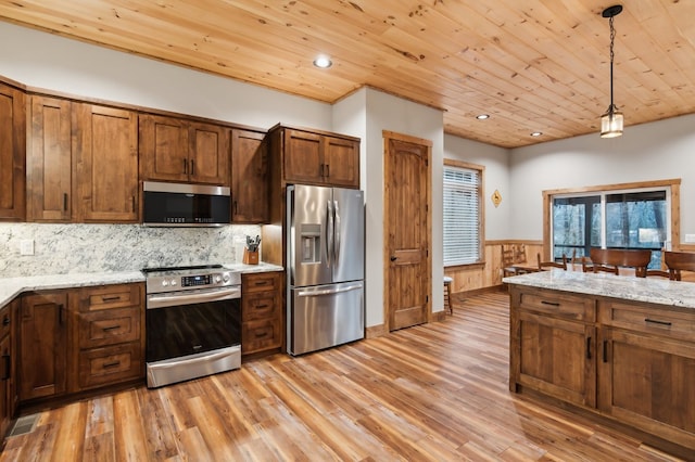 kitchen with appliances with stainless steel finishes, wood ceiling, hanging light fixtures, and light stone counters