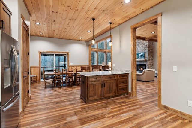 kitchen featuring a wainscoted wall, decorative light fixtures, stainless steel refrigerator with ice dispenser, recessed lighting, and wood ceiling