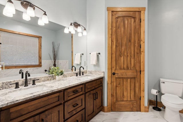 full bath with double vanity, marble finish floor, a closet, and a sink