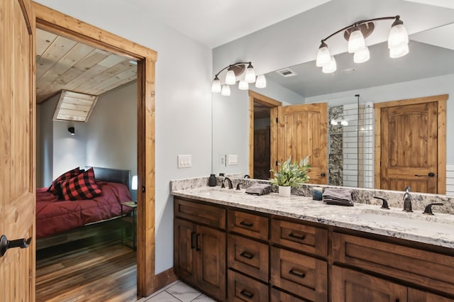 ensuite bathroom featuring double vanity, visible vents, a sink, and ensuite bathroom