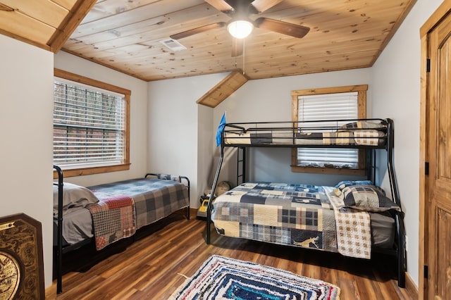 bedroom with dark wood-style floors, vaulted ceiling, and wood ceiling