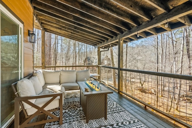 wooden terrace with an outdoor living space