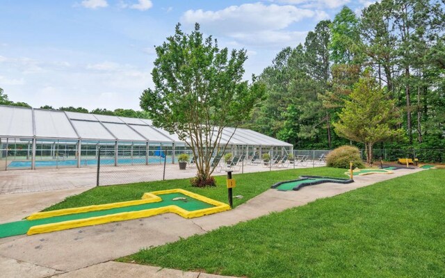 surrounding community with fence and a lawn