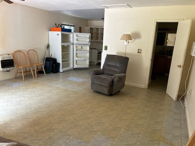 living area with ceiling fan and tile patterned floors