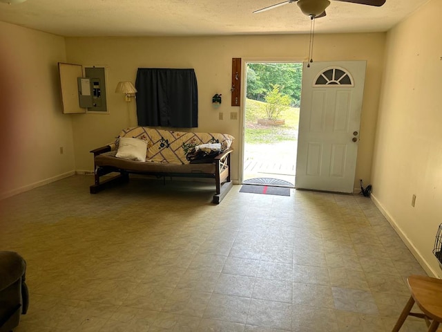 tiled foyer featuring electric panel and ceiling fan