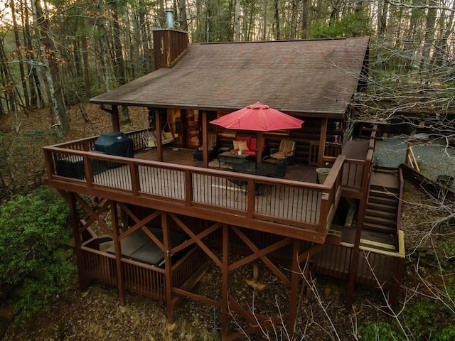 exterior space featuring a deck and a view of trees