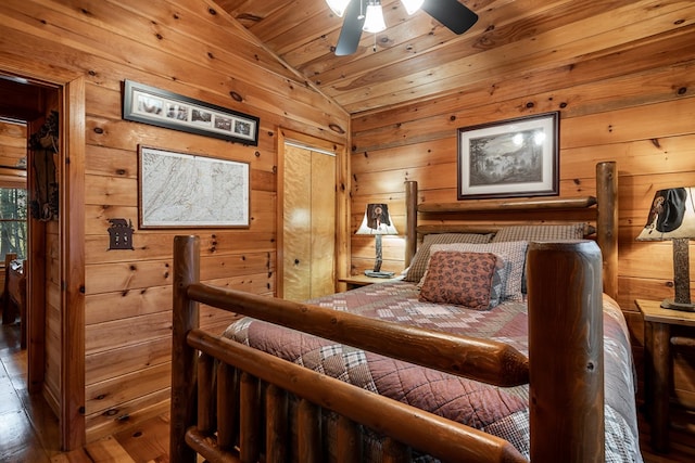 bedroom featuring lofted ceiling, wooden ceiling, and wood walls