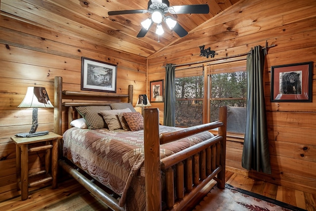 bedroom with vaulted ceiling, wood walls, wooden ceiling, and hardwood / wood-style flooring