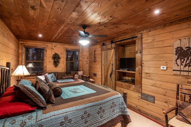 bedroom featuring carpet, visible vents, a barn door, wooden walls, and wooden ceiling