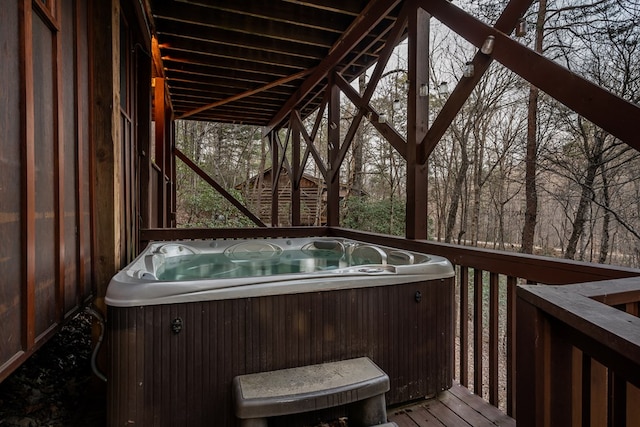 wooden deck featuring central AC unit and a hot tub