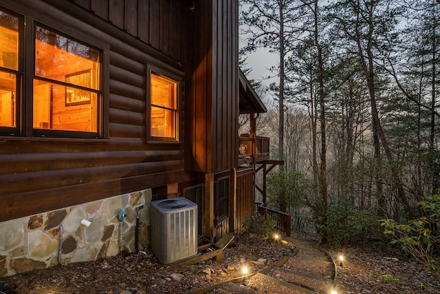 view of property exterior featuring central AC unit and board and batten siding