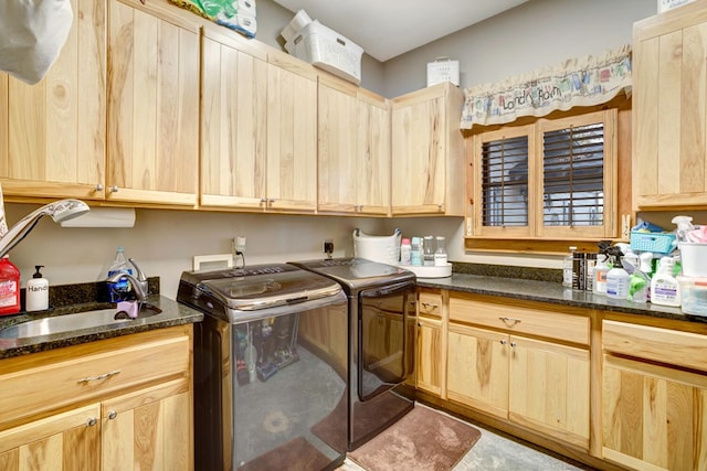 laundry area with separate washer and dryer, a sink, and cabinet space