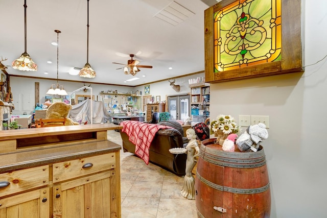 misc room featuring crown molding, ceiling fan, and light tile patterned floors