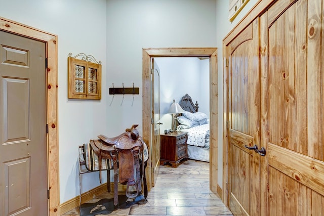 hallway with baseboards and wood finished floors