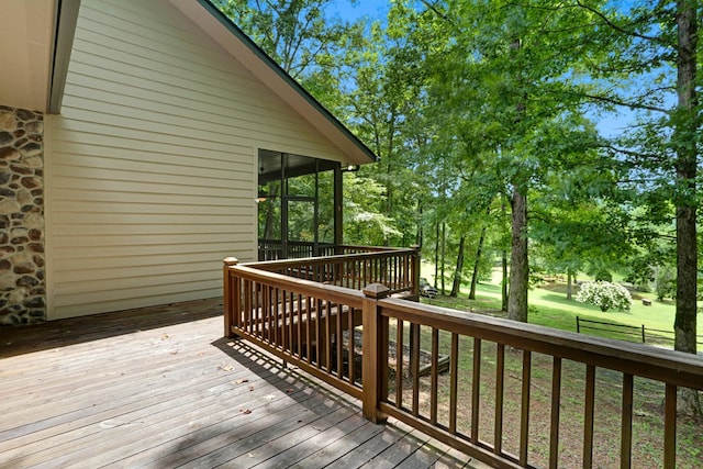 deck with a yard and a sunroom