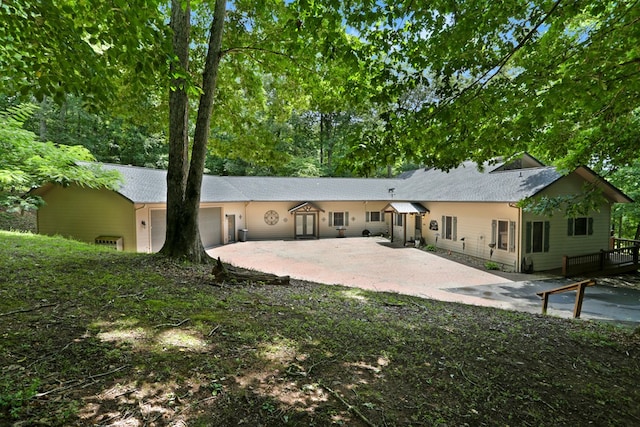 rear view of property featuring an attached garage