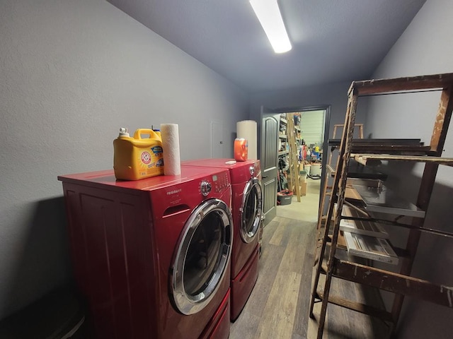 laundry area with separate washer and dryer, laundry area, and wood finished floors